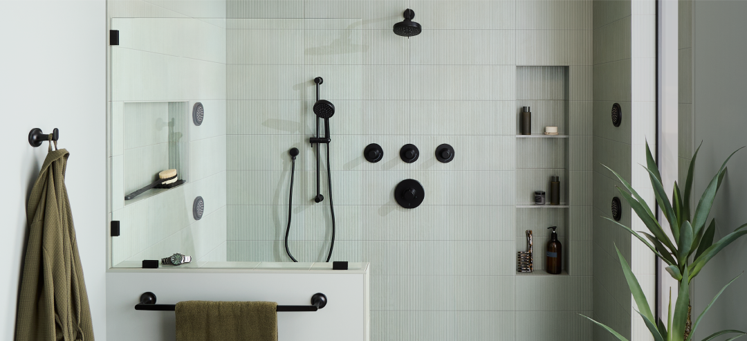 Healer bathroom with the Lentz Pressure Balance Shower System, FundamentALL Hand Shower, Shower Head, Body Sprays, Lentz Robe Hook, Towel Rod in matte black