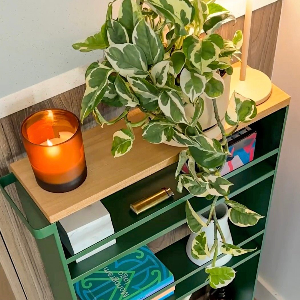 Forest Green Slim Storage Cart shown with a candle and house plant in a modern home