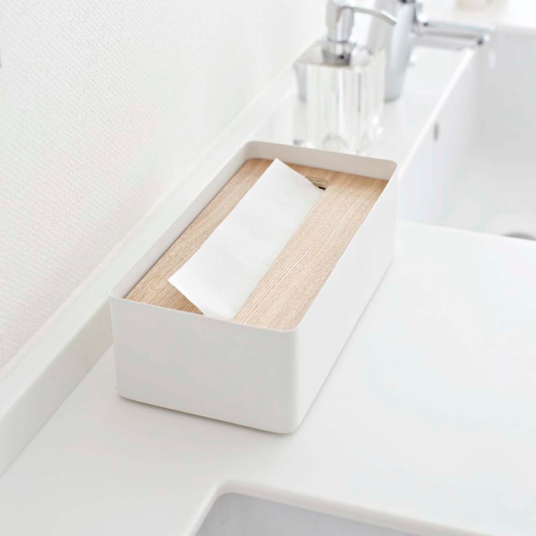 Side view of white Tissue Box on bathroom sink countertop by Yamazaki Home.