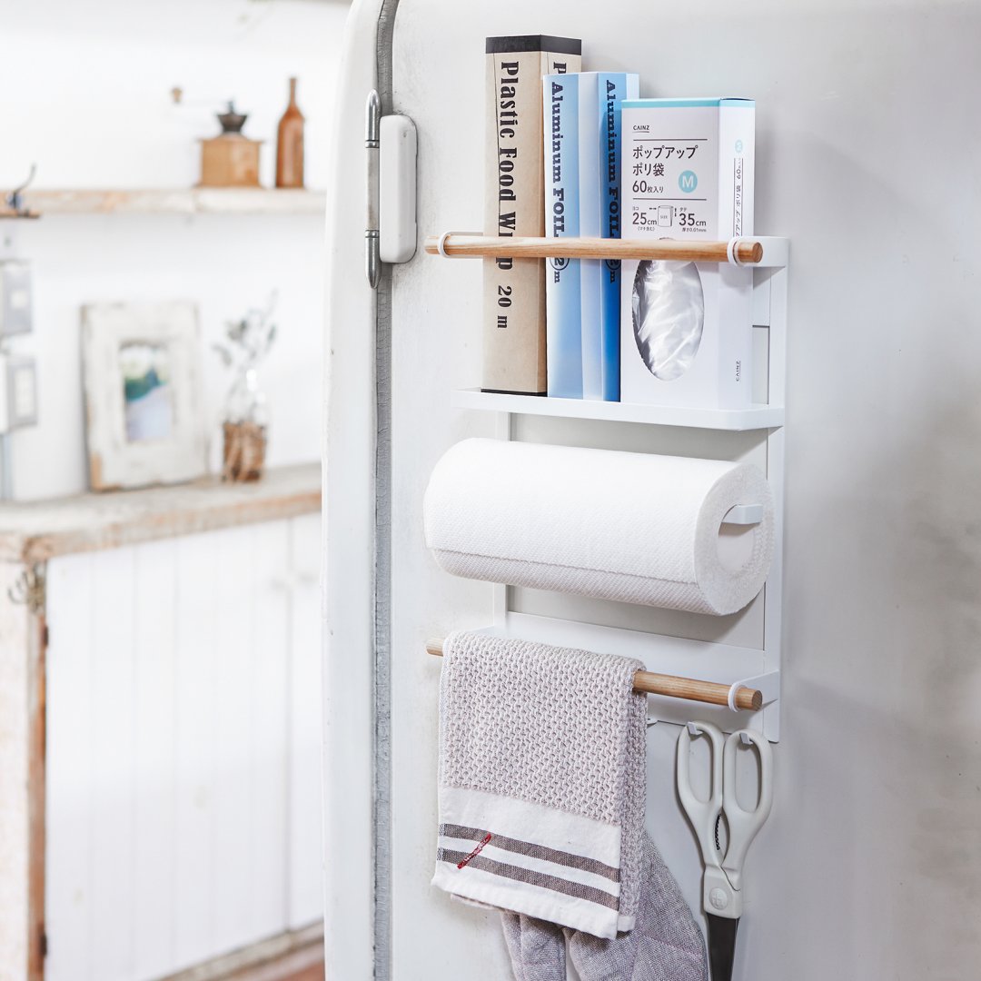 magnetic kitchen organizer stuck to the side of refrigerator with various supplies inside