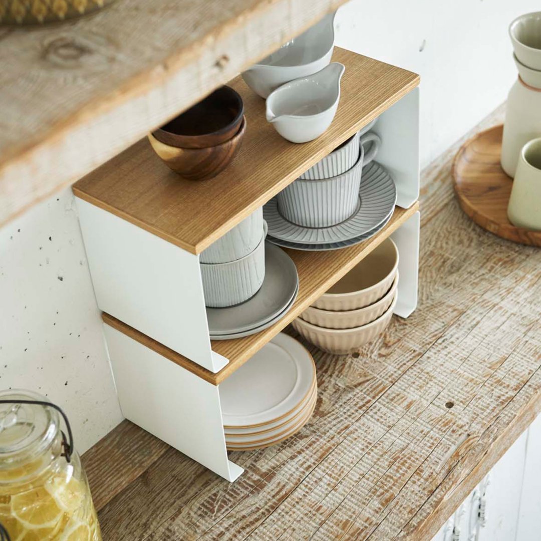 Two of Yamazaki Home Stackable Countertop Shelf - Steel + Wood on top of each other on a counter.